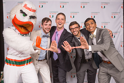 Sebastian the Ibis throwing the U with Students 